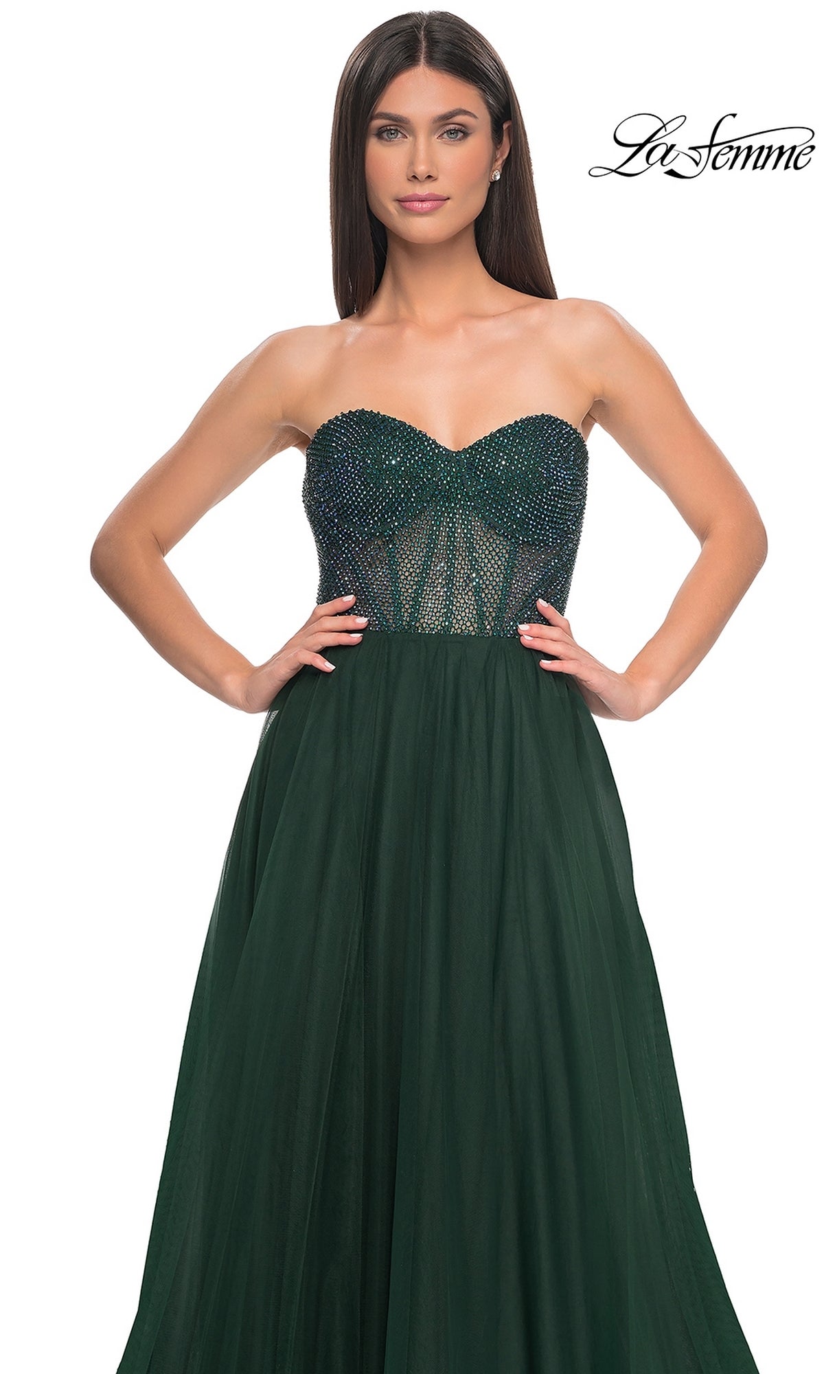 A woman poses against a white background in the La Femme Strapless Long A-Line Prom Dress 32216, dark green with a beaded semi-sheer bodice and tulle skirt.